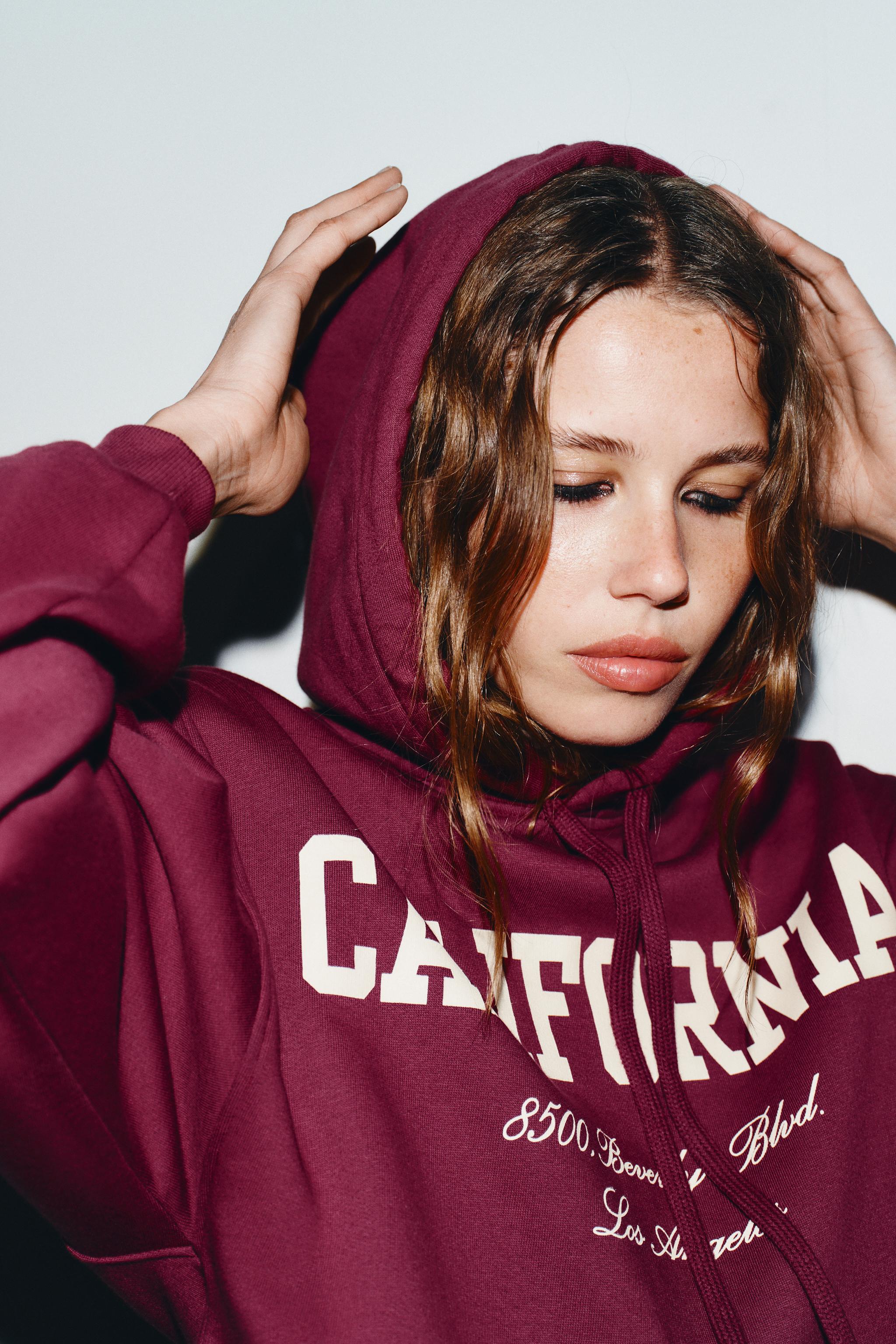 RUFFLED VARSITY SWEATSHIRT